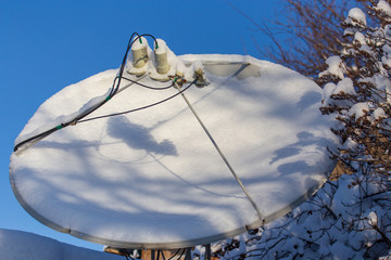 Satellite dish in the snow in winter