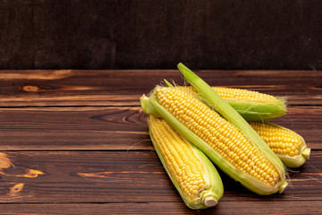 Corn cobs on wooden table.