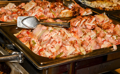 silver plate filled with plenty pieces of pizza