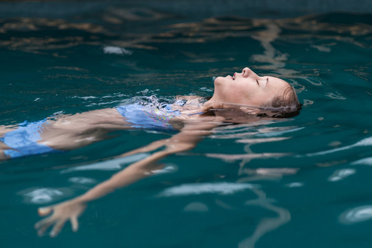 tween floating in pool