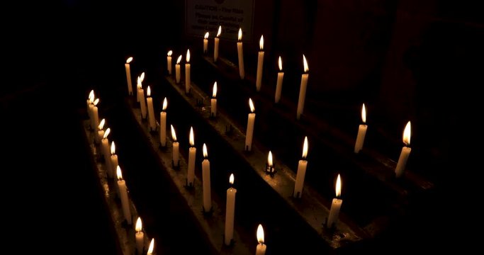 Carlisle Cathedral prayer candles as offering dark England. The Cathedral Church of the Holy and Undivided Trinity. Cumbria, North West England. Augustinian priory. Ancient wood and stone work.