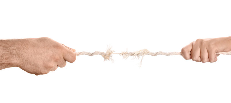 Man And Woman Pulling Frayed Rope At Breaking Point On White Background