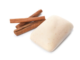 Soap bar and cinnamon sticks on white background
