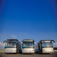 Three buses staying in the parking lot Front Way
