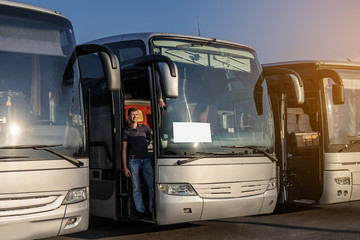 Driver staying in the front door of his bus © Med Photo Studio