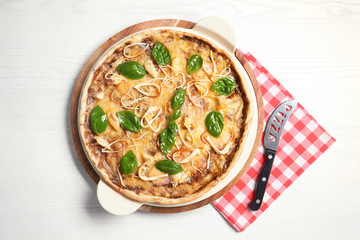 Delicious homemade pizza served on wooden table, top view
