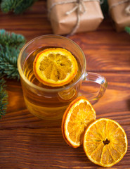 Festive table for the new year and Christmas with a Christmas tree, an orange and gifts
