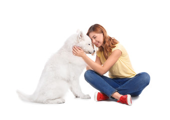 Beautiful woman with her cute dog on white background