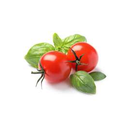 Fresh green basil leaves and cherry tomatoes on white background