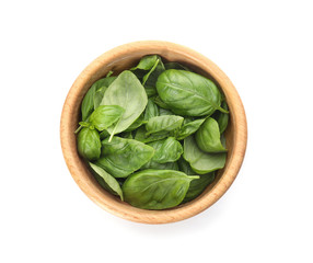 Bowl of fresh green basil leaves on white background, top view