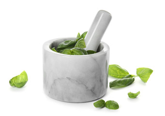 Mortar with fresh green basil leaves on white background