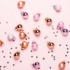 Holiday Christmas pink flat lay with golden balls and confetti