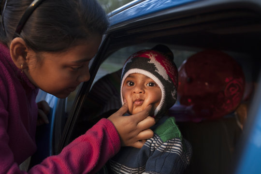 Sisters showing affection  to younger one