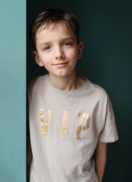 Portrait of a handsome tween wearing a VIP motif t-shirt