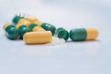 Pain killer capsules called "Tramadol HCL" with drug powder on white background.Tramadol HCL 50 mg