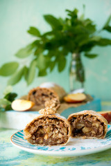 Apple strudel with raisins on a light background