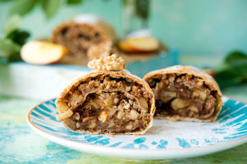 Apple strudel with raisins on a light background