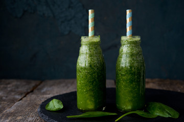 Green vitamin smoothie from spinach in a bottle