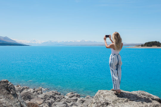 Woman soaking up scenic view at lake