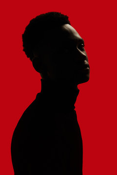 African American man portrait profile silhouette isolated over red - looking at camera