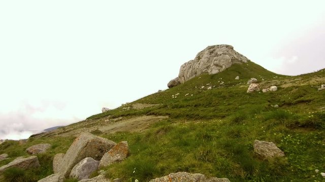 Bucegi mountains walking at Bucegi Plateau High mountain with low thick and mystic clouds. Babele rocks Formation