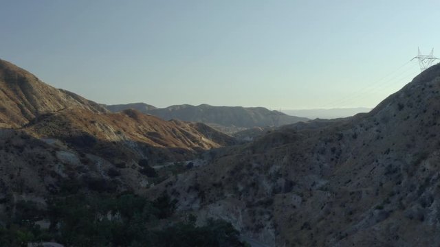 Flying over grassy mountainous terrain.