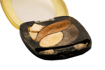 Colored crashed eyeshadow for make up isolated on white background. Close up of a make up powder.