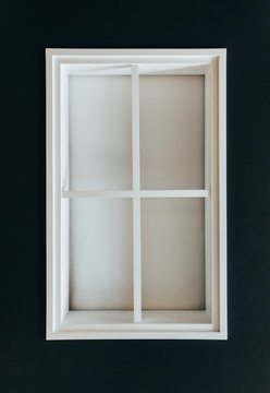 White window frame on a black wall