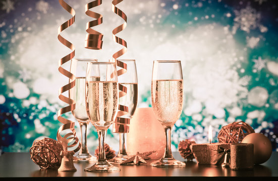 champagne glasses against holiday lights ready for New Year's eve party