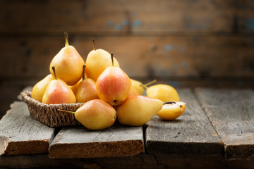 Fresh pears  in a box on wooden table.