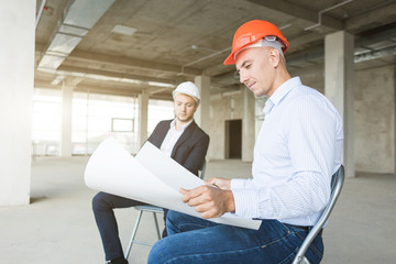 men engineers builders working at the table with a laptop, business negotiations at the...
