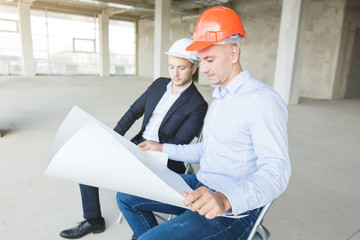 men engineers builders working at the table with a laptop, business negotiations at the...