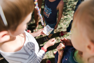 kids reading a note as part of a game at party