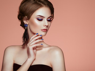 Portrait Beautiful Woman with Jewelry. Model Girl with Blue Manicure on Nails. Elegant Hairstyle. Blue Make-up Arrows. Beauty and Accessories