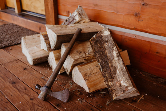 Rustic Pile of Wood with Axe