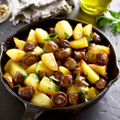 Roasted potatoes with mushrooms and sausages