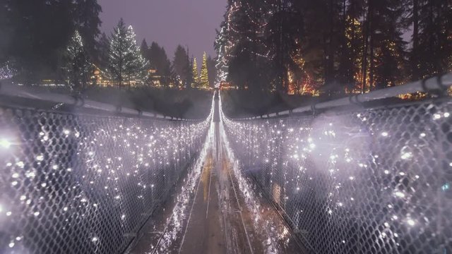 Long Suspension bridge decorated with Christmas lights, Rainy night