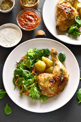 Grilled chicken leg with potato and green salad