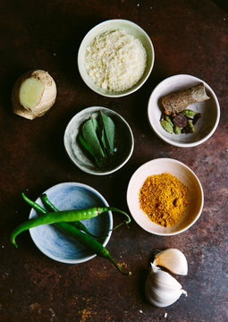 Spices and aromatics for an Indian curry dish.