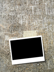 Blank rectangular instant photo frame on old weathered wall