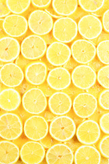 A slices of fresh juicy yellow lemons.  Texture background, pattern.