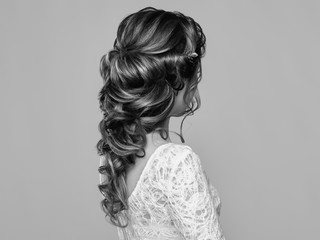 Brunette Woman with Long and shiny Curly Hair. Beautiful Model Lady with Curly Hairstyle. Care and Beauty Hair products. Care and Beauty of Hair