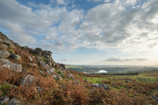 Stunning Autumn sunset landscape image of view from Leather Tor towards Burrator Reservoir in Dartmoor National Park