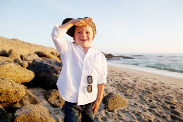 Young Boy At Beach Wearing Military Tags And Saluting