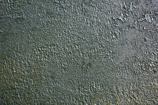 Old green peeling paint on the armored fighting vehicle. Rusty dye background texture.