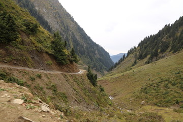 River and track passing through under mountains