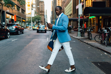 Young businessman walking in the street in New York City