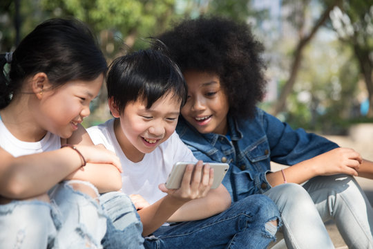 Group of kids watching  video on phone