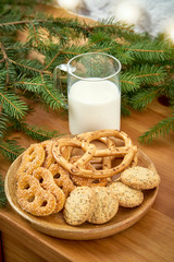 Christmas plate with delicious cookies on an old shelf on the background of a white brick wall