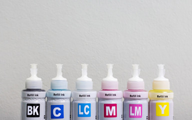 Dry ink bottle for printer machine and copyspce background. CMYK color for printing business.